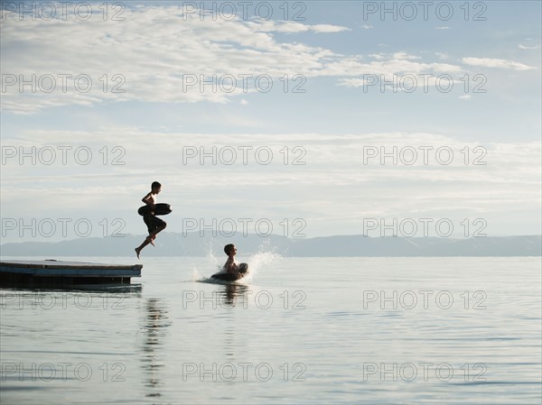 Boys (10-11,12-13) jumping from raft.