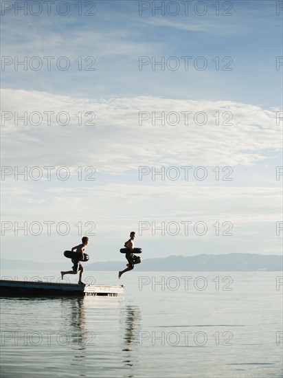 Boys (10-11,12-13) jumping from raft.