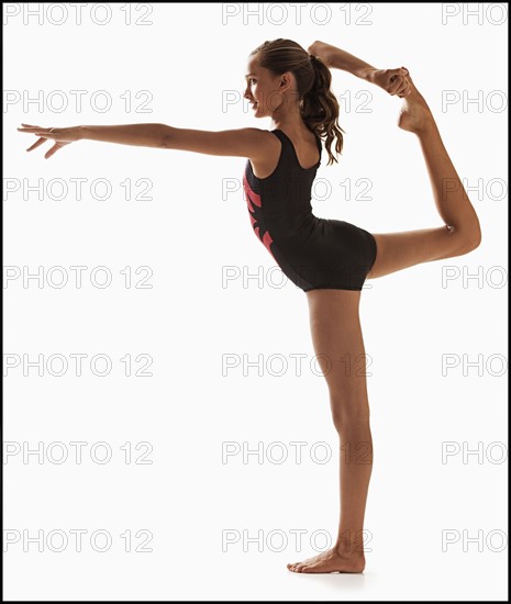 Female gymnast (12-13) balancing on one leg. Photo : Mike Kemp