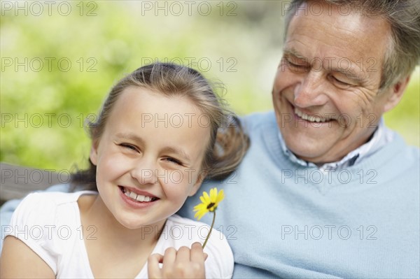 Happy grandfather and granddaughter (10-11). Photo : Momentimages