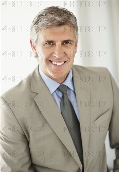 Portrait of cheerful businessman. Photo : Momentimages