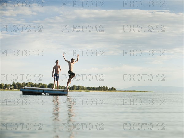 Boys (10-11,12-13) jumping from raft.