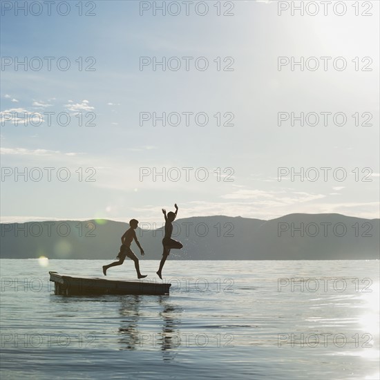 Boys (10-11,12-13) jumping from raft.