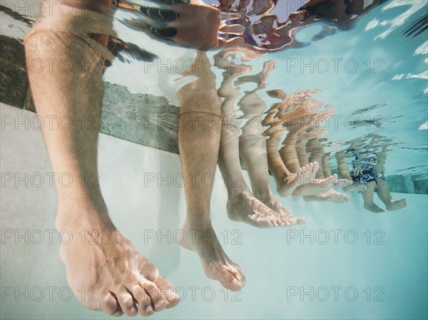 Family with four kids (12-18months, 4-5,6-7,8-9) on swimming pool.