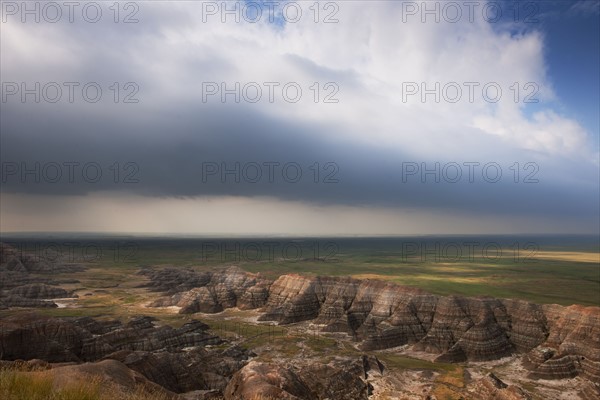 USA, South Dakota, Thick gray clouds over mountains in Badlands National Park.