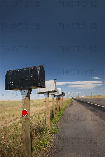 USA, South Dakota, Row of rural mailboxes on roadside.