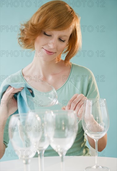 Young woman cleaning wineglasses. Photo : Jamie Grill