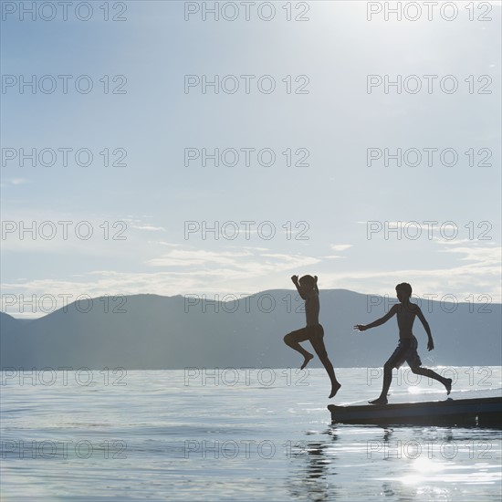 Boys (10-11,12-13) jumping from raft.