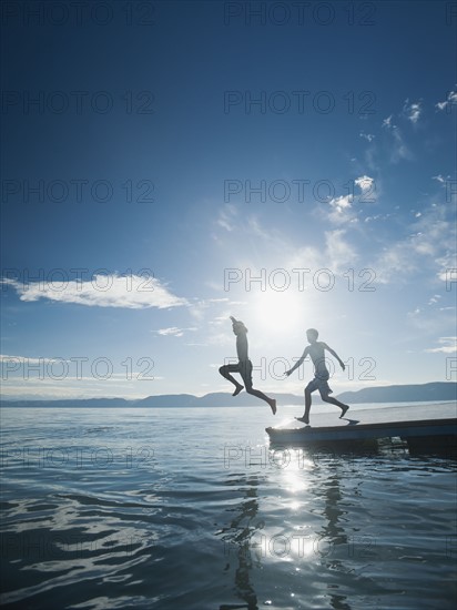 Boys (10-11,12-13) jumping from raft.