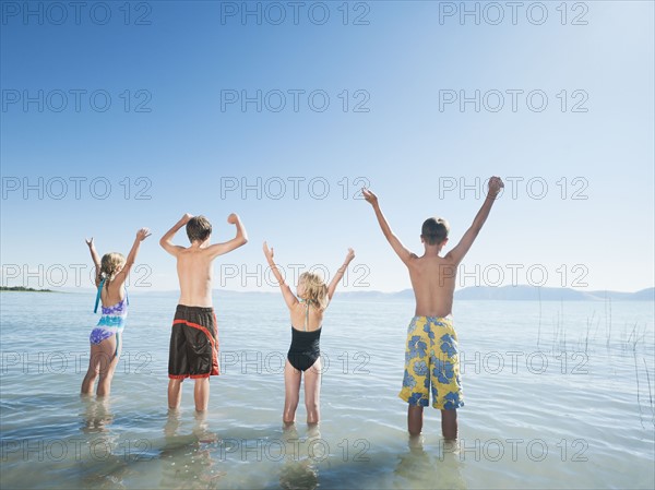 Kids (6-7,8-9,10-11,12-13) playing in lake.