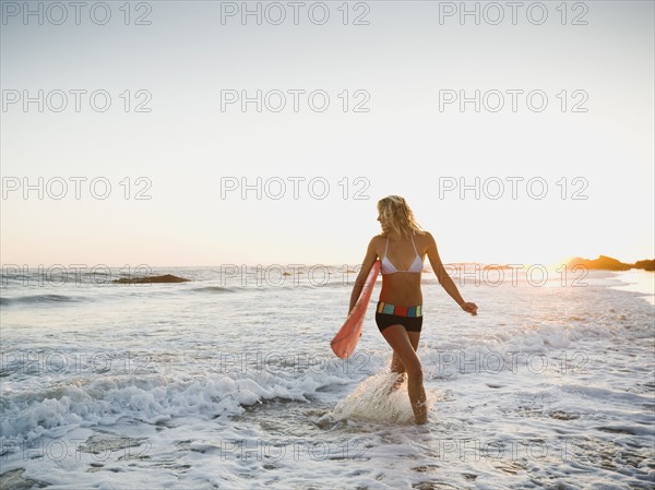 Portrait of woman with surfboard.