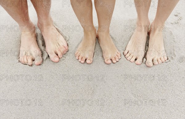 Family at beach, low section. Photo : Momentimages