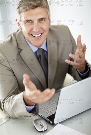 Portrait of businessman with laptop. Photo : Momentimages