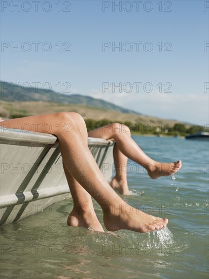 Girls (6-7,8-9) resting on boat.