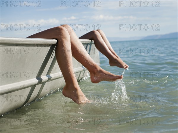 Girls (6-7,8-9) resting on boat.