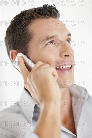 Portrait of good-looking mid adult man with mobile phone. Photo : Momentimages