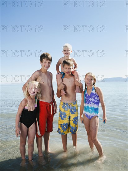 Kids (2-3,6-7,8-9,10-11,12-13) playing in lake.