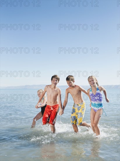Kids (6-7,8-9,10-11,12-13) playing in lake.