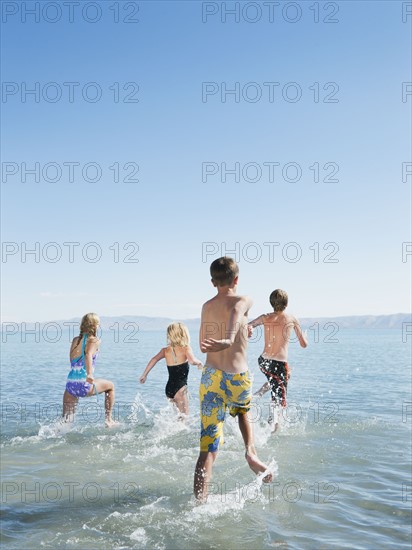 Kids (6-7,8-9,10-11,12-13) playing in lake.