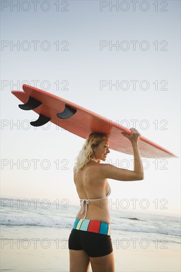 Portrait of woman with surfboard.