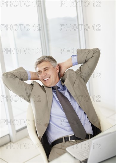 Portrait of businessman with laptop. Photo : Momentimages