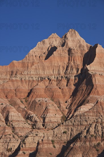 USA, South Dakota, Mountain against blue sky in Badlands National Park.