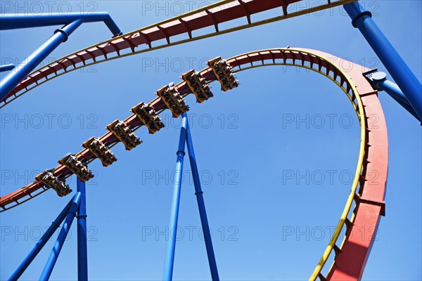 Rollercoaster against blue sky. Photo : fotog