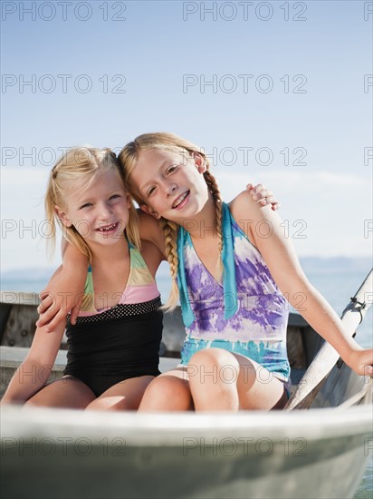 Girls (6-7,8-9) resting on boat.