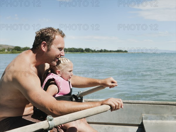 Father and daughter (2-3) on boat.