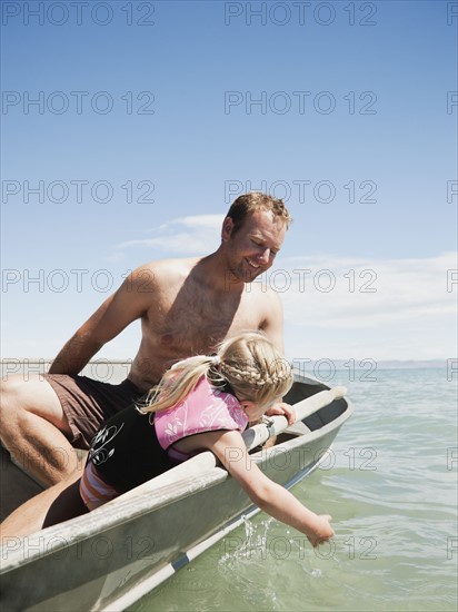 Father and daughter (2-3) on boat.