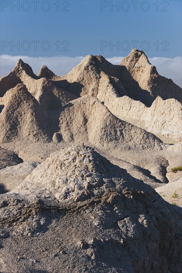 USA, South Dakota, Mountain against blue sky in Badlands National Park.