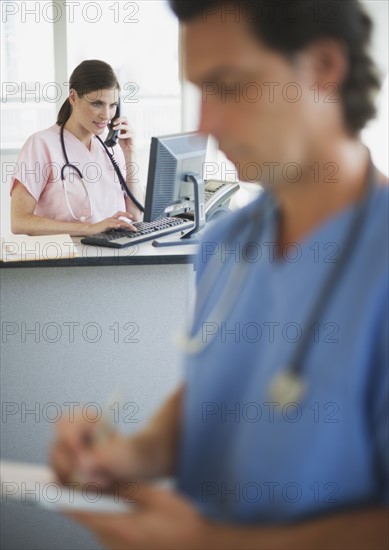 Doctor writing documentation in hospital.