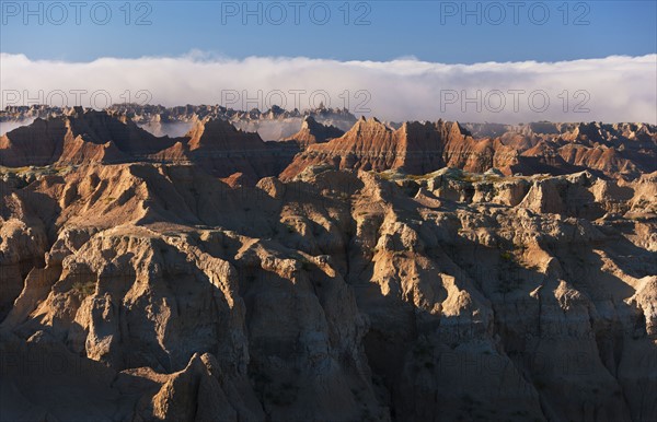 USA, South Dakota, Mountains in morning fog in Badlands National Park.