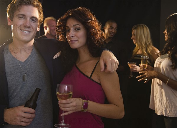 Portrait of couple embracing at nightclub. Photo : Jamie Grill