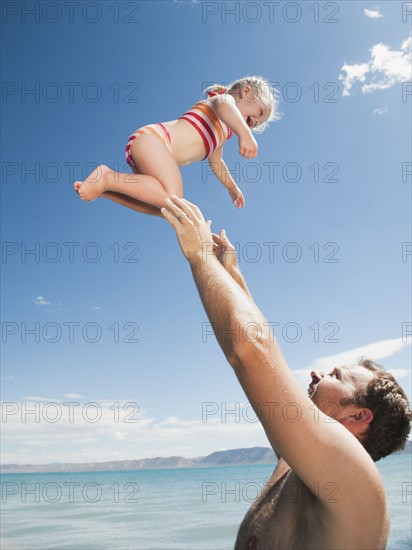 Father and daughter (2-3) playing.