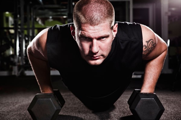 Mid adult man working out in gym. Photo : Take A Pix Media