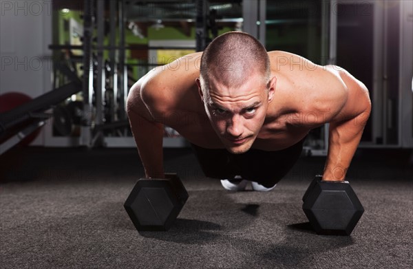 Mid adult man working out in gym. Photo : Take A Pix Media