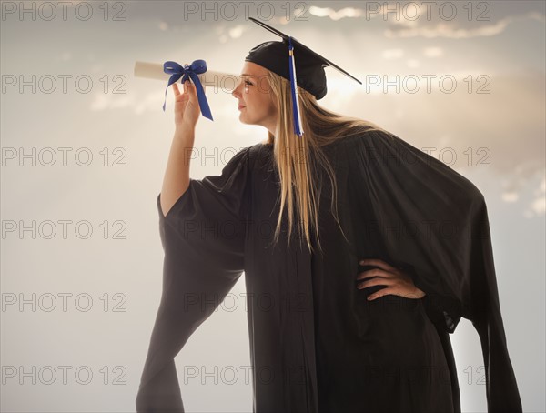 Young girl (16-17) wearing graduating gown. Photo : Mike Kemp