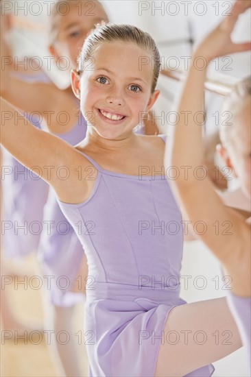 Portrait of female ballet dancer (6-8) in dance studio. Photo : Mike Kemp