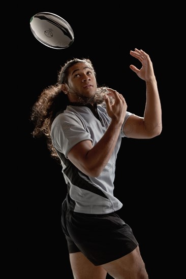 Male rugby player catching ball. Photo : Mike Kemp