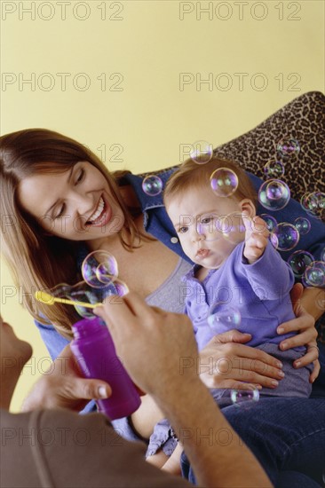 Baby playing with bubbles. Photo : Fisher Litwin