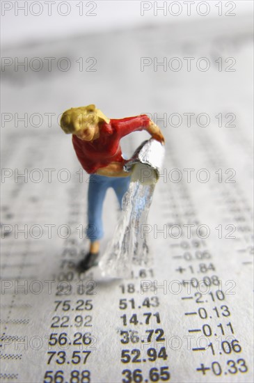 Model woman pouring water on financial figures. Photo : Antonio M. Rosario