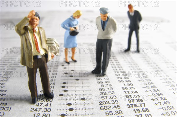 Business figurines on financial figures. Photo : Antonio M. Rosario