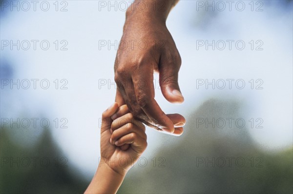 Child holding adult's hand. Photo : Fisher Litwin