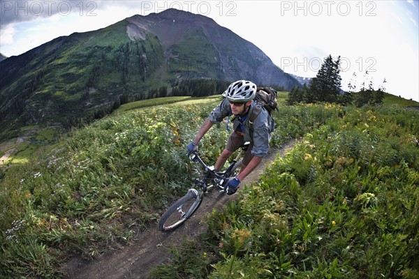 Man mountain biking on trail. Photo : Shawn O'Connor