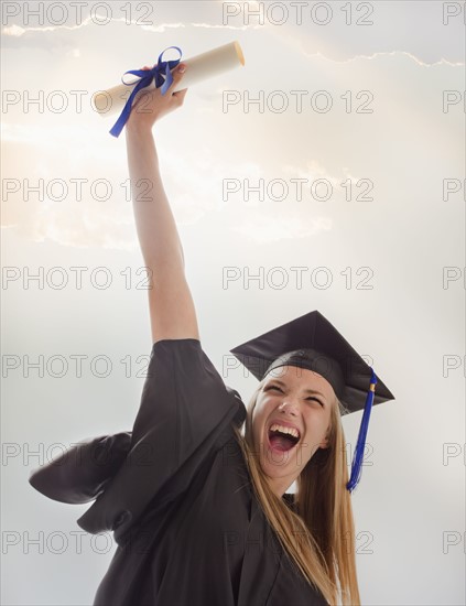 Young girl (16-17) wearing graduating gown. Photo : Mike Kemp