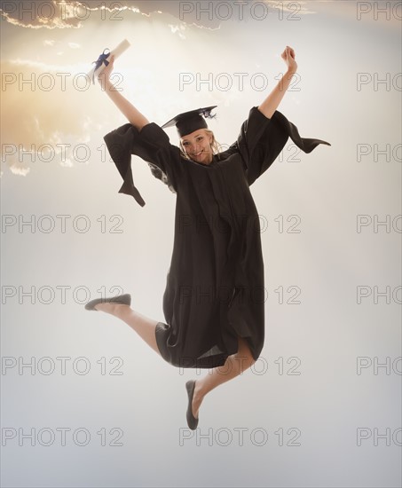 Young girl (16-17) wearing graduating gown. Photo : Mike Kemp