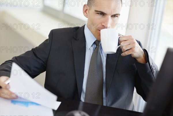 Businessman working in office. Photo : Momentimages