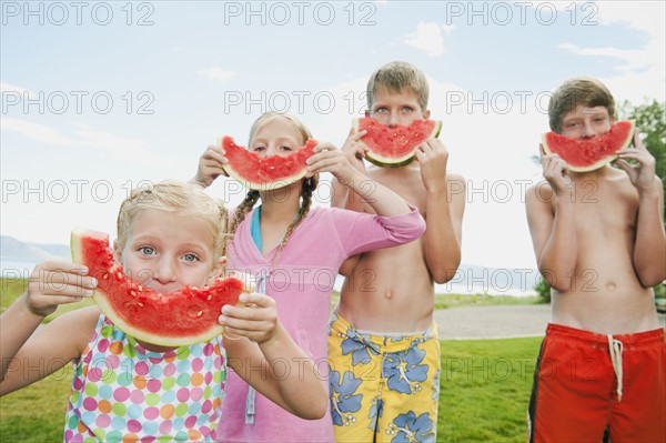 Kids (6-7,8-9,10-11,12-13) eating watermelon.