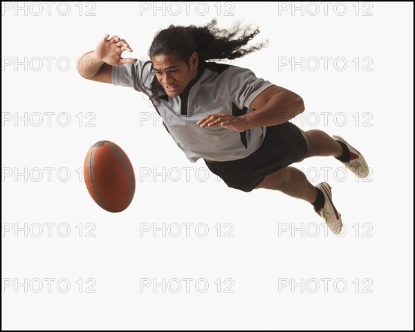 Male rugby player diving for ball. Photo : Mike Kemp